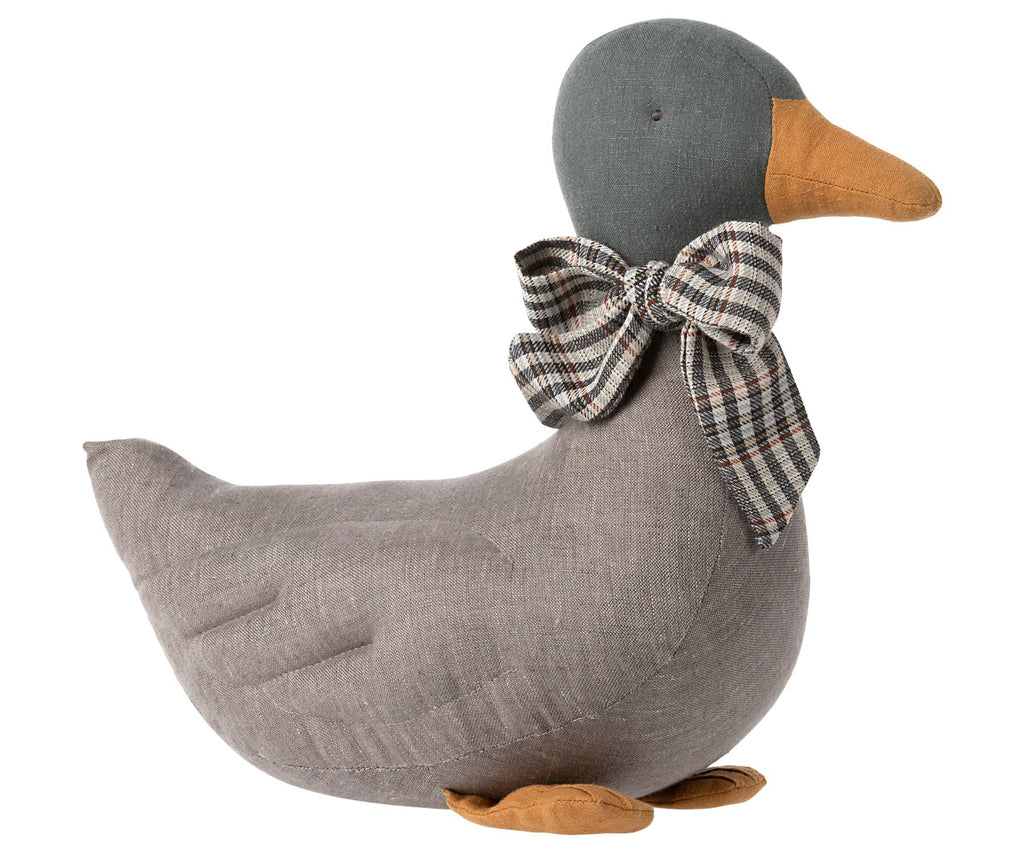 A Maileg Duck Stuffed Animal - Gray with a plaid bow around the neck, featuring a grey body and orange beak and feet, isolated on a white background.