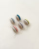 Five colorful Wooden Yoyos with striped designs and white strings, arranged in a circle on a pale background.