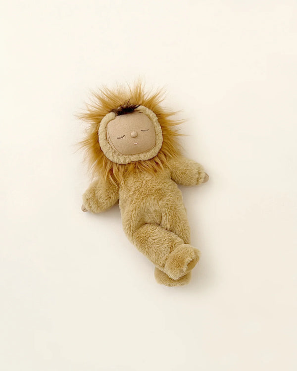 A Olli Ella Cozy Dinkum Doll - Lion Pip with a fluffy mane and an embroidered face, lying on a light beige background.