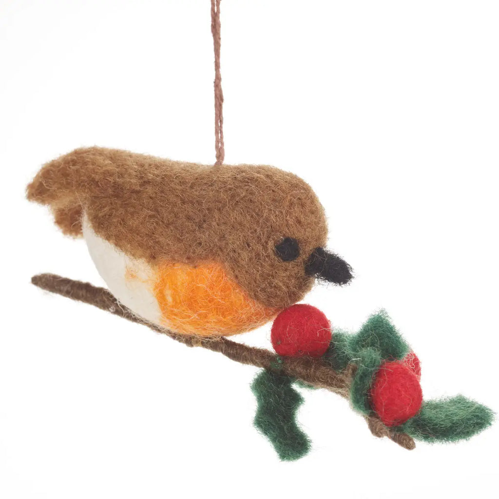 A needle-felted wool ornament depicting a Handmade Felt Robin on a Holly Branch Ornament, hanging by a string, set against a white background.