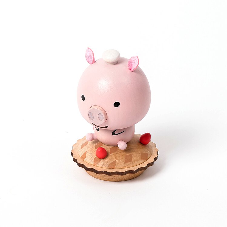 A cute, pink Wooden Pig Bobblehead toy with a minimalistic design, sitting on a round wooden base. The piggy has wide eyes, a small snout, and red feet.