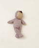 Sleeping doll in purple pajamas. 