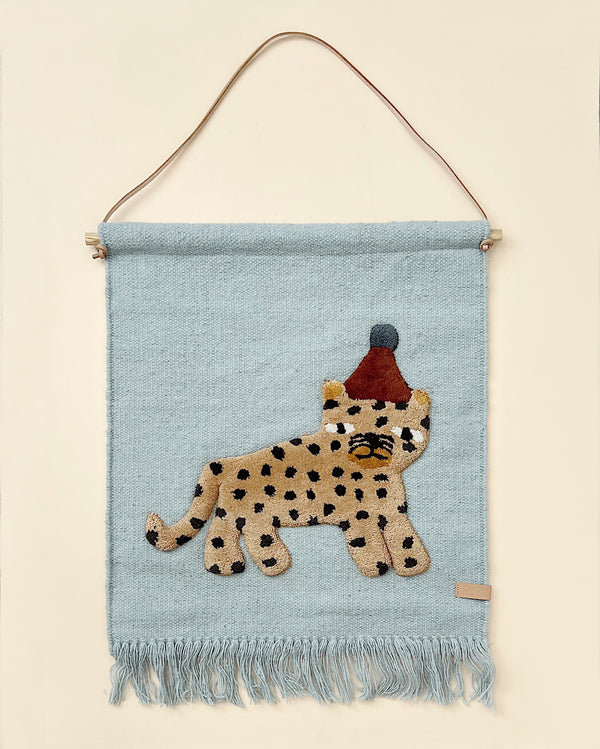 Woven wall hanging with a picture of a leopard