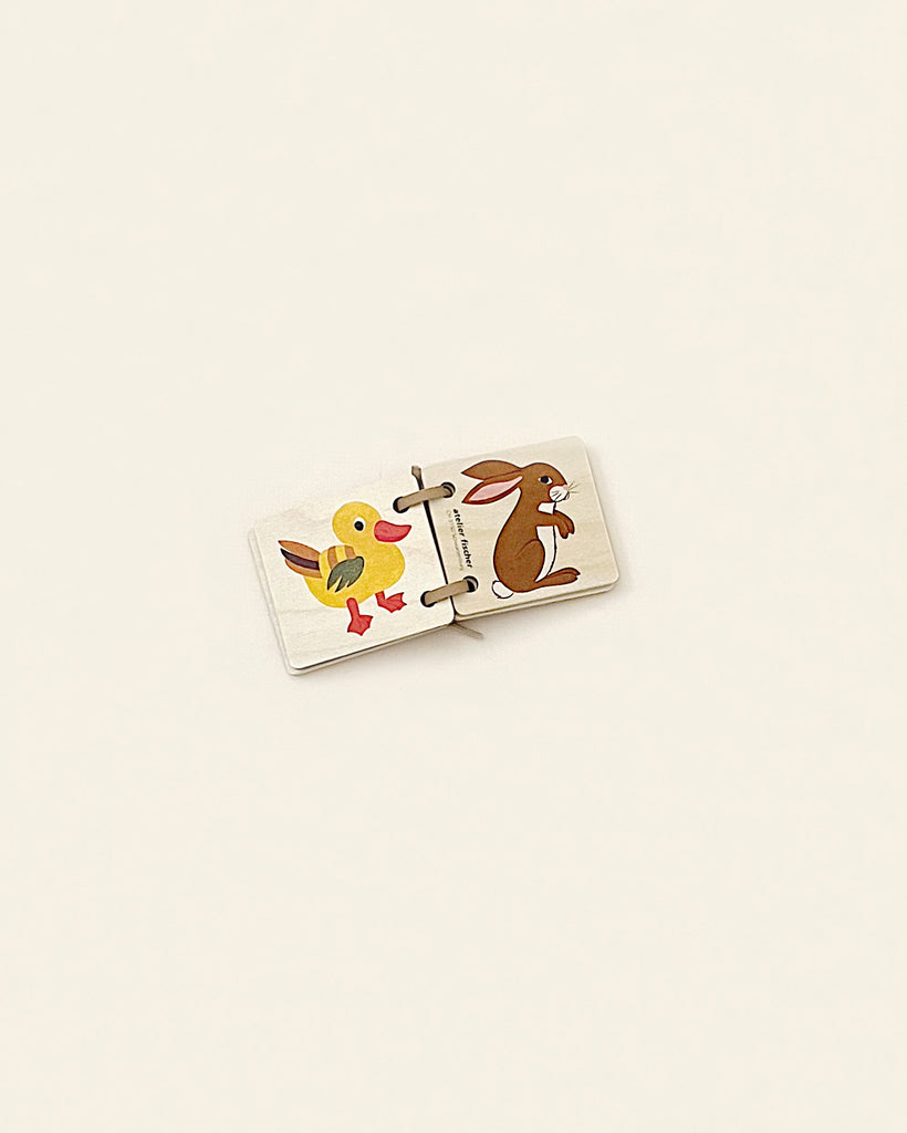 Two-piece puzzle on a plain background, made in Switzerland, featuring a cartoon duck on the left and a cartoon bunny on the right, both in a playful design.