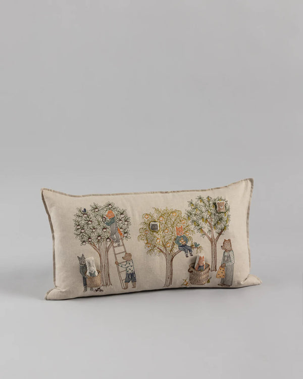 A rectangular decorative pillow from the Coral & Tusk Orchard Pocket Pillow series, featuring a whimsical print of cats and birds sitting amidst stylized trees on a light beige background.
