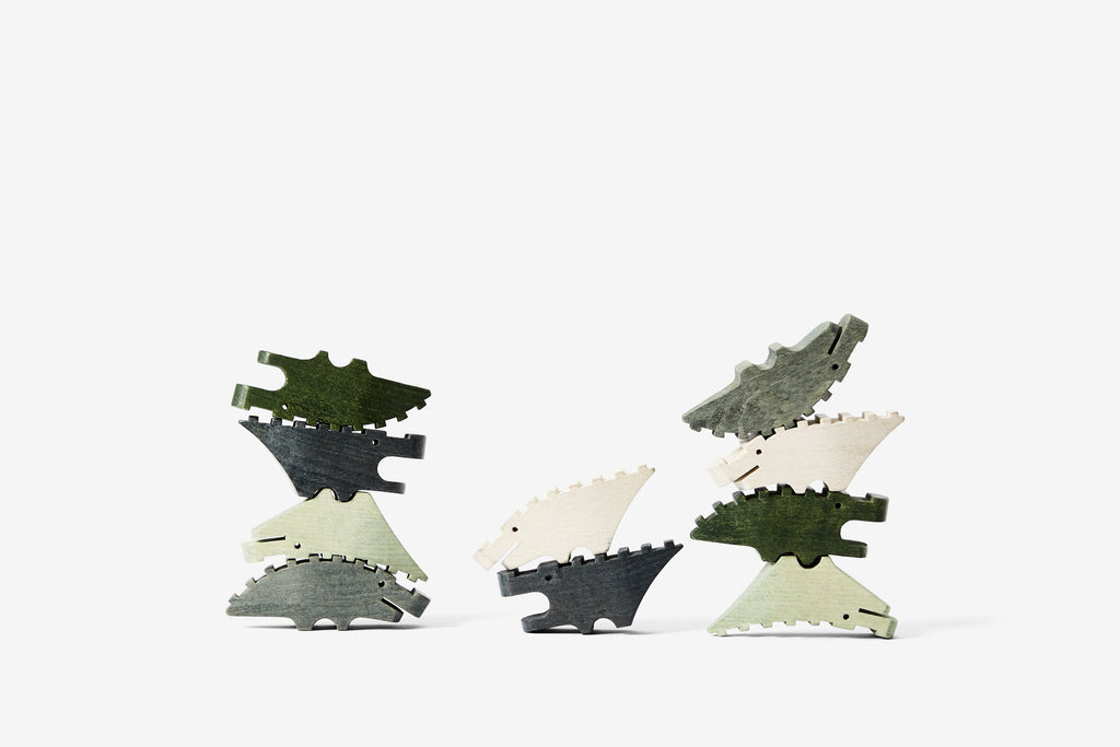 10 wooden stackable crocodile shaped pieces in various shades of green, photographed in three different stacks.