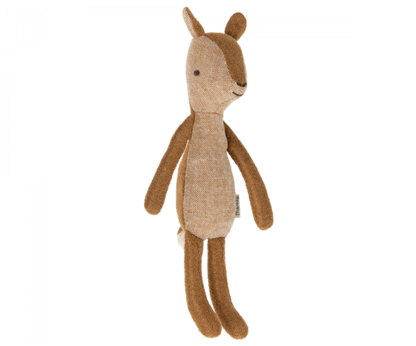 A small deer stuffed animal photographed on a flat background.