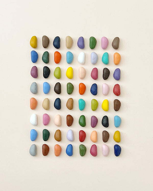 An array of colorful, Non-Toxic 64 Piece Crayon Rocks meticulously arranged in a grid pattern against a neutral background, featuring a wide range of colors including blues, greens, reds, and yellows