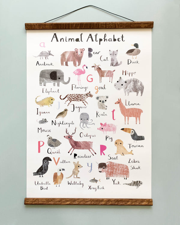 Animal Alphabet Poster hanging on a wall, featuring colorful drawings of animals with corresponding letters a to z, such as anteater, bear, cat, and so on.