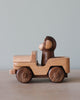 Wooden car toy with a monkey as the driver. 