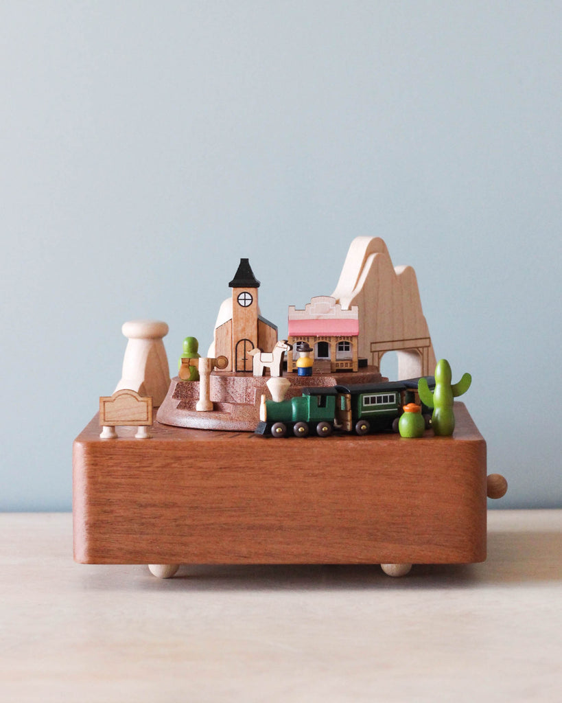 Wooden music box with the theme of a Western town and a train going around