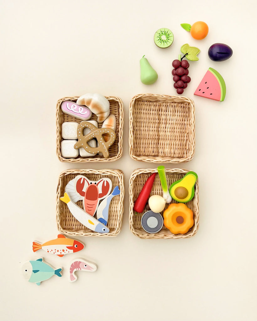 Four handcrafted Market Baskets containing colorful wooden toys: fruits in one, sea creatures in another, toy food and utensils in one, and toys resembling baked goods in the last, all arranged on