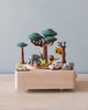 Wooden music box with a tree in the middle with African animals. A small wooden jeep going around the music box. 