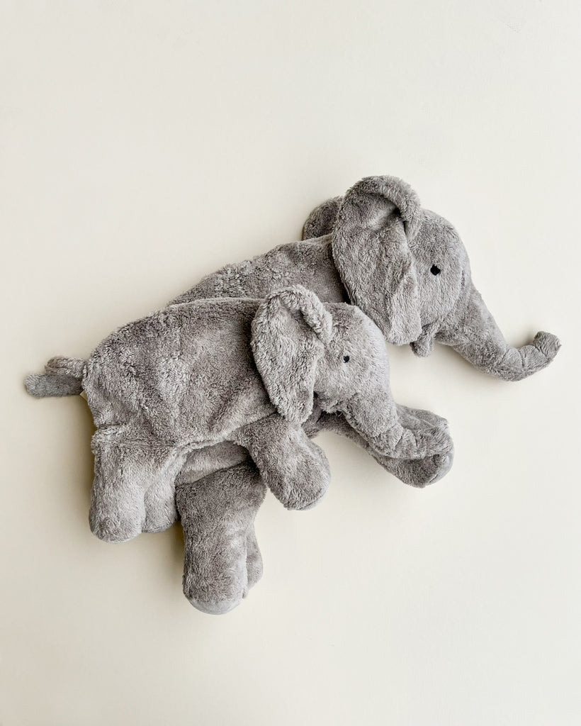Two Senger Naturwelt Cuddly Animal - Elephant toys, one smaller than the other, closely nestle together against a plain light background, creating a sense of comfort and companionship.
