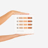 Two hands holding a Gathre Micro Rainbow Mat color swatch palette with various shades displayed against a white background.