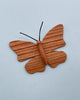 A Handmade 11-Piece Wooden Insects sculpture, hand-crafted from alder ash wood, with detailed, textured wings and a smooth body, displayed against a plain light blue background.