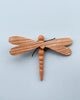 A hand-crafted Handmade 11-Piece Wooden Insects with detailed wings and segmented body, displayed on a plain light blue background.