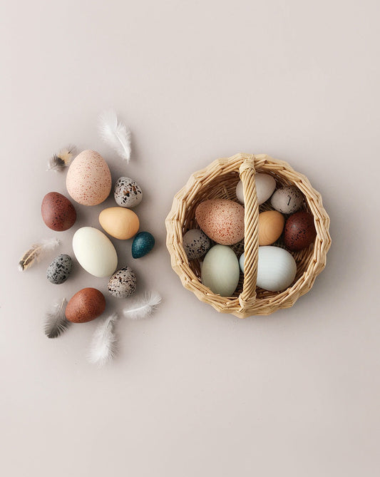 A Dozen Wooden Bird Eggs In A Basket