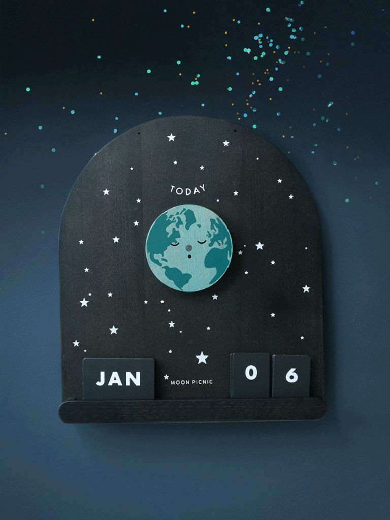 Me & The Moon – Moon Phase Calendar featuring a circular, rotating earth, surrounded by stars on a dark, arched background; displaying "today", "jan", and "06" with magnetic moon discs below.