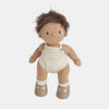 A soft, cuddly Olli Ella Dinkum Doll with brown skin and tousled dark hair, dressed in a beige sleeveless romper and brown shoes, standing against a white background.