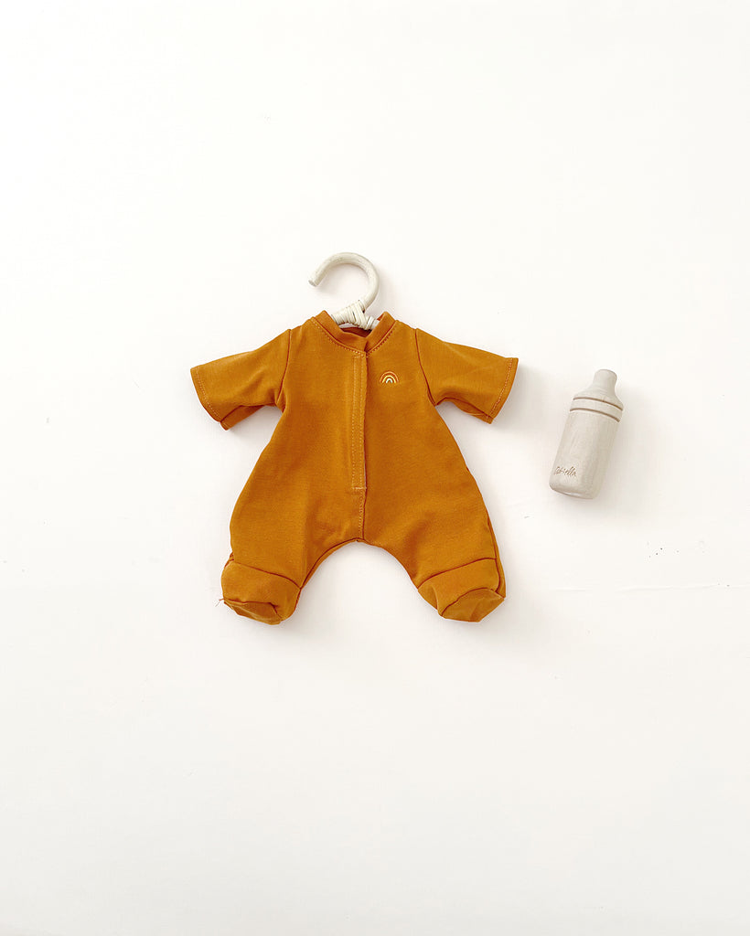 A mustard-colored baby onesie displayed alongside a baby bottle, all set against a plain white background, perfect for matching with Olli Ella Dinkum Doll Extra Clothing.