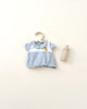 A baby's Olli Ella | Dinkum Doll Extra Clothing on a hanger next to a wooden baby bottle, set against a plain light background.