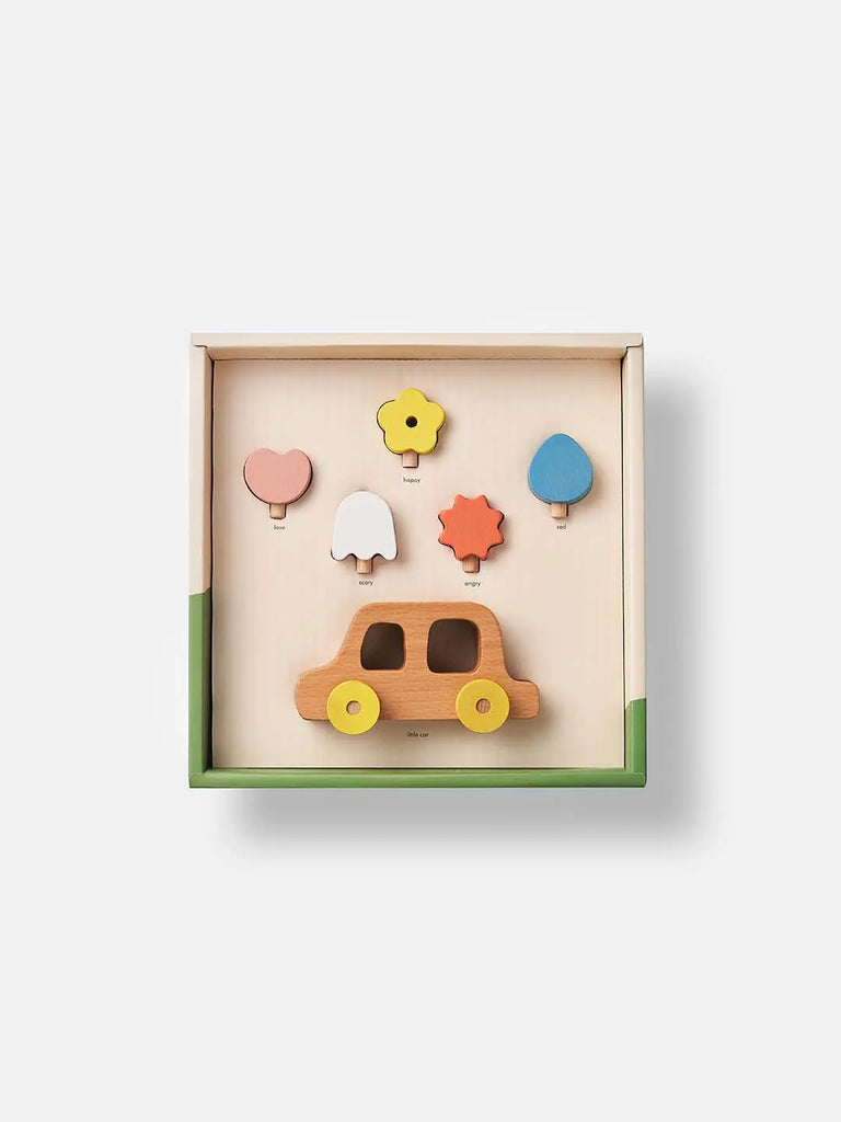 My Little Car toy car in a box with colorful tree-shaped pieces stored above it, isolated on a white background.