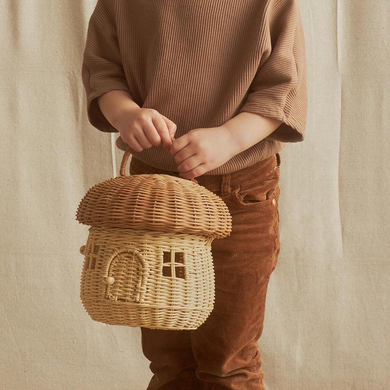 Child holding rattan mushroom basket