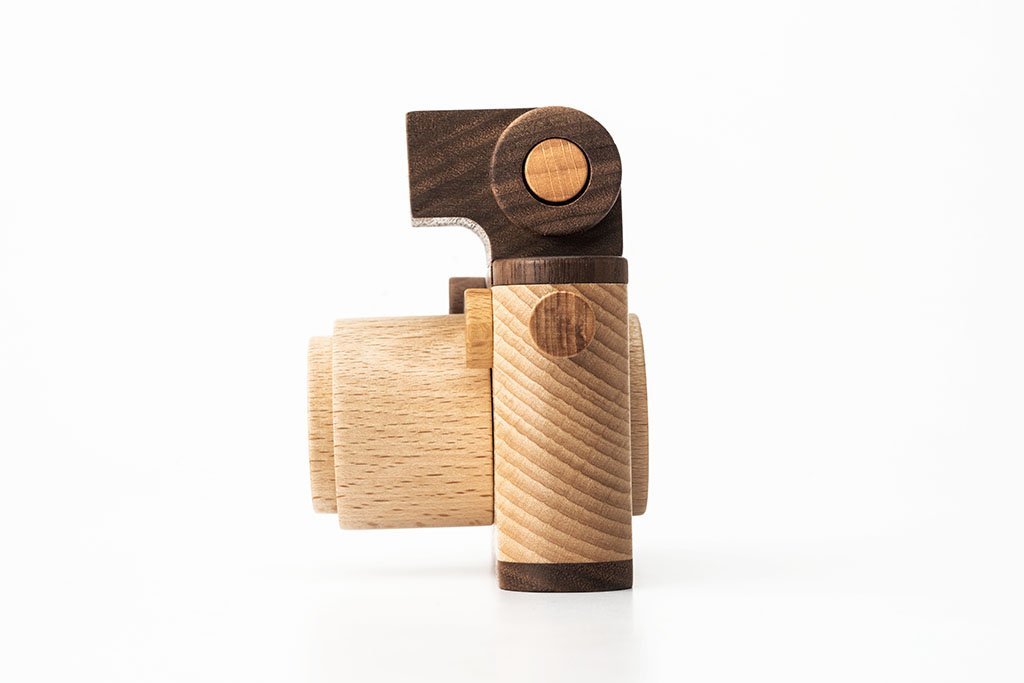 Father’s Factory | Vintage Style Wooden Toy Camera made of light and dark wood with a simplistic design, placed against a plain white background.
