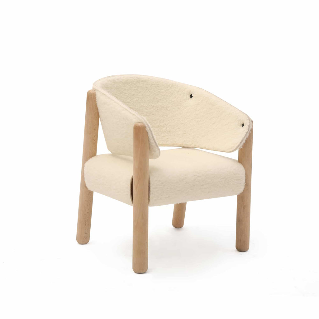 A Charlie Crane SABA Chair 'Fur' with a minimalist design featuring a white cushioned, curved backrest and seat. The chair has four raw beech wood legs and an open, airy aesthetic, combining comfort and style with the elegance of Italian felt details.