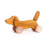 Wooden dachshund dog push toy photographed against white background. 