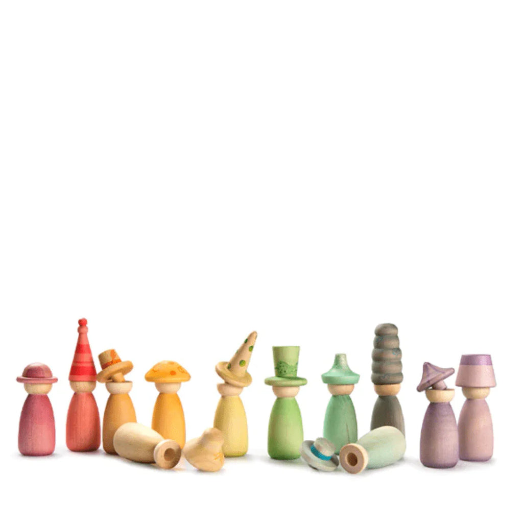 A collection of colorful, assorted Grapat Fancy Nins wooden toy figurines arranged in a line against a white background. The shapes vary from simple cones to more intricate designs with curves and layered segments.