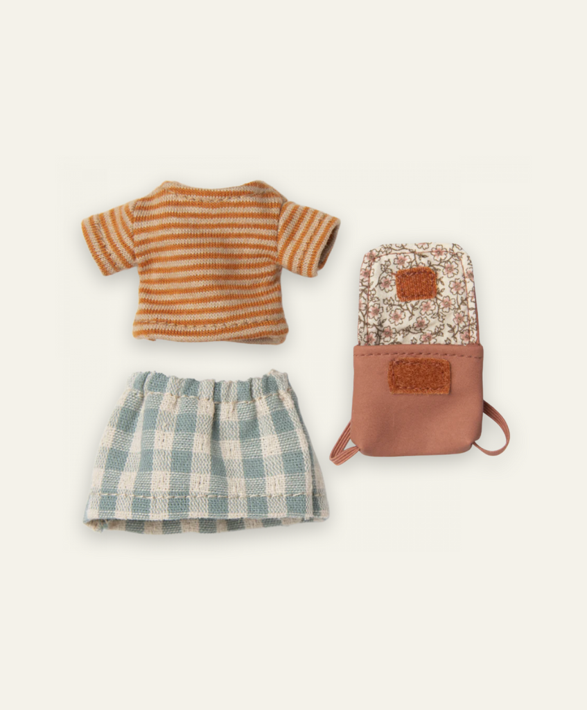 An overhead view of Maileg Extra Clothing: Clothes & Bag for Big Sister - Old Rose, featuring a striped orange and white t-shirt, a green and white checkered skirt, and a floral backpack with tan accents.
