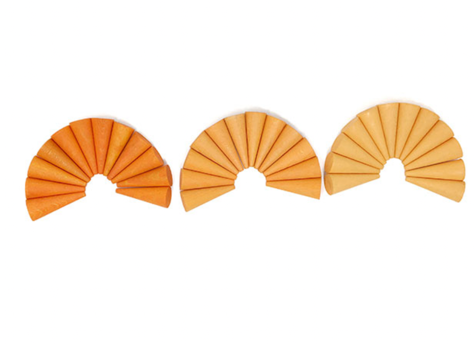 Three slices of Grapat Mandala Orange Cones arranged in a semicircular pattern, ranging from thinly sliced to wedges, colored with non-toxic dyes and isolated on a white background.