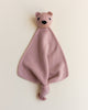 A small merino wool lovey in blush color with a head of a teddy bear at the top.