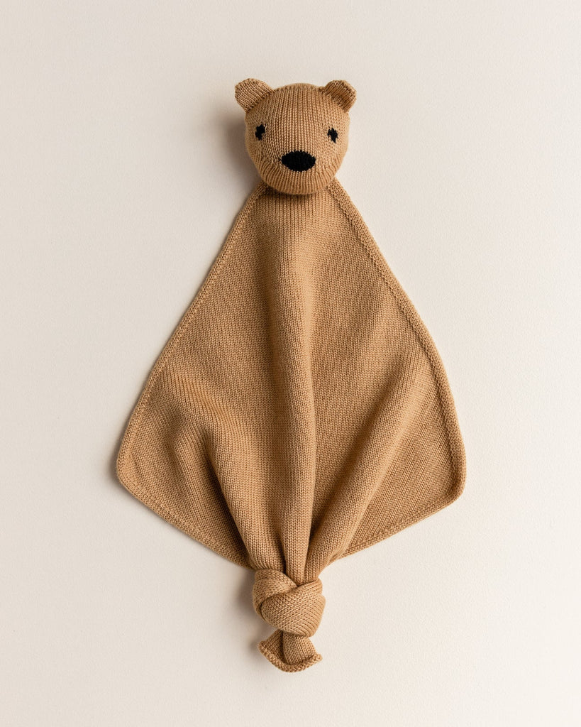 A small merino wool lovey in ochre color with a head of a teddy bear at the top.