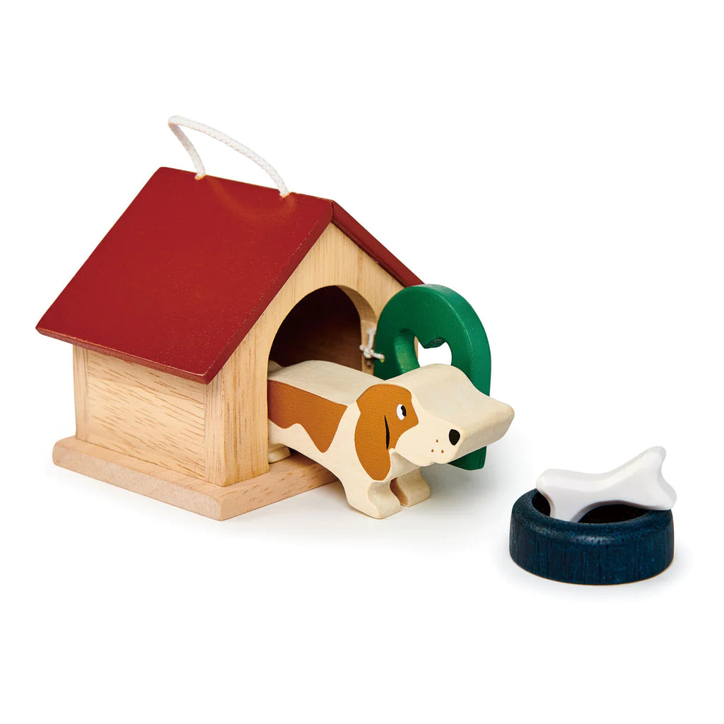 A Doghouse Set with an opening door and a red roof, featuring a small basset hound dog with a green collar peeking out. Beside it are a blue bowl and a white