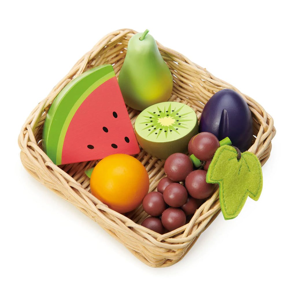 A collection of colorful wooden fruit toys including a watermelon, kiwi, pear, plum, orange, and grapes, arranged in the Market Basket on a white background.