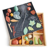 A My Forest Floor containing various colorful wooden shapes including trees, leaves, and rocks, arranged next to a stylized board depicting a nature scene.
