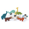 A sustainable rubber wood toy set depicting The Friend Ship Pull Toy with various animal figures including an elephant, giraffe, and whales, alongside two human figures, all arranged on a white background.