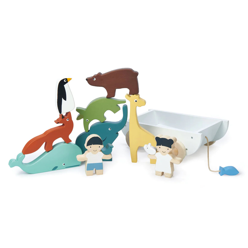 Colorful wooden animal set featuring various animals, such as a penguin, bear, kangaroo, dolphin, shark, giraffe and a small human figure beside The Friend Ship Pull Toy with a blue fish.