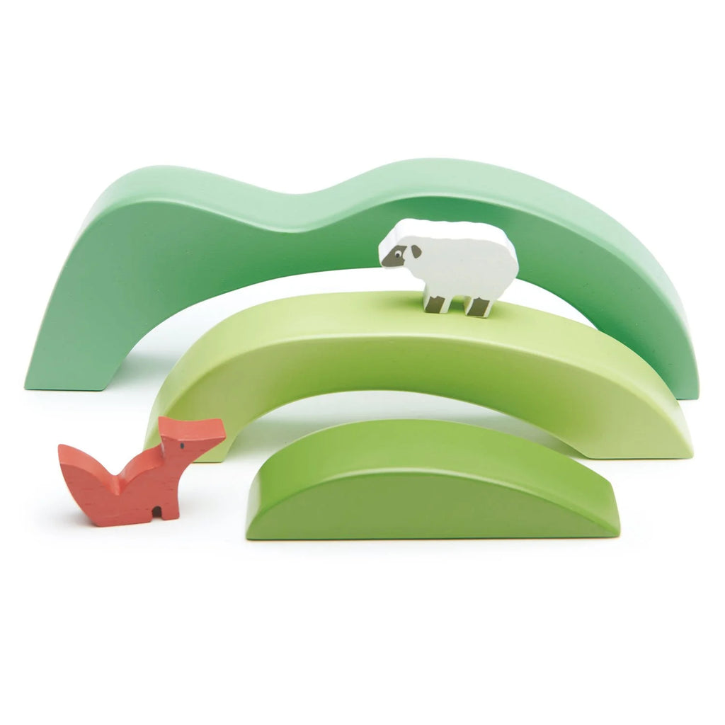 A Green Hill Stacker featuring three solid wood hills as nesting arches with a toy sheep on the top arch and a toy fox on the middle arch, all set against a white background.