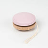 A pink painted Wooden Yoyo with a white string, isolated on a white background.