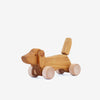 Wooden dachshund dog push toy. White background. 