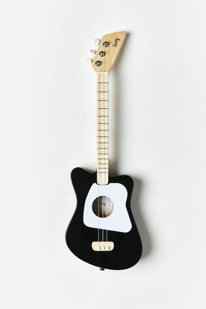 A wooden kid's guitar painted in black and white.