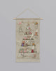 A Coral & Tusk Embroidered Advent Calendar shaped like a tree, decorated with pockets featuring various festive designs and small gifts, hanging from a wooden rod against a plain background.