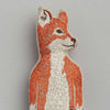 A detailed embroidery of a Coral & Tusk Fox Pocket Doll with predominantly orange and white threads, showcasing a lifelike and textured portrayal of the animal holding strawberries, against a plain gray background.