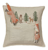 Coral & Tusk Winter Foxes Pocket Pillow featuring an embroidered woodland scene with foxes on a fox hunt in snow, a bear, two deer, and three pine trees on a neutral beige background.