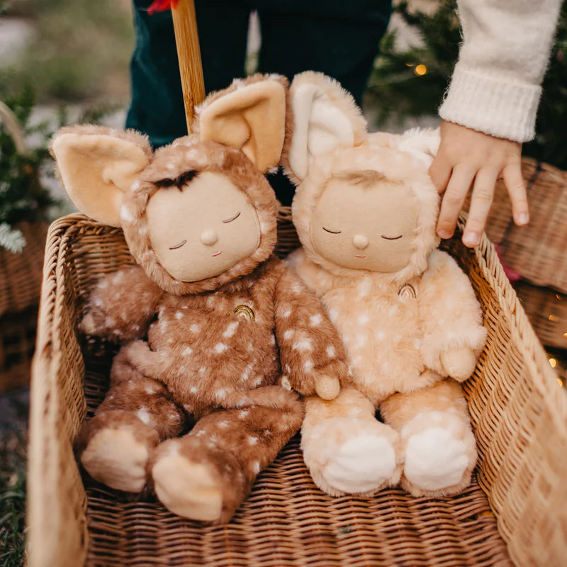 Two stuffed dolls in deer costumes photographed in a rattan wagon. 