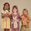 children holding soft baby dolls
